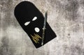 Black thieving balaclava with automatic knife and war bullets Royalty Free Stock Photo