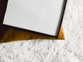 Black thin wooden frame with blank copyspace as poster photo print mockup, golden cushion pillow and fluffy white Royalty Free Stock Photo