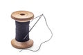 Black thread on an old wooden spool and sewing needle Royalty Free Stock Photo