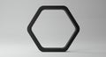 A black, three-dimensional hexagonal frame stands upright against a plain gray Royalty Free Stock Photo
