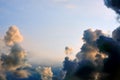 Black thundercloud sunset divides the sky in half. Beautiful clouds in the rays of sunlight, copy space. Dark storm clouds leave