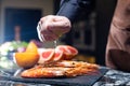 Black Tiger Shrimps. Chef hand squeezing lemon juice dribbling out of fruit. Roasted prawns with herbs. Grilled seafood Royalty Free Stock Photo