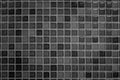 Black tile wall high resolution real photo or brick seamless pattern and texture interior room background. Dark grid tiles wall