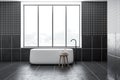 Black tiled bathroom interior with tub Royalty Free Stock Photo