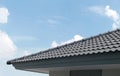 black tiles roof on a new house with blue sky and cloud background Royalty Free Stock Photo