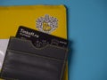 Black Tinkoff Bank debit card in corporate card holder and yellow envelope.