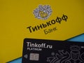 Black Tinkoff Bank debit card and corporate yellow envelope Royalty Free Stock Photo