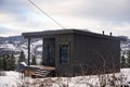 Black tiny cabin decorated for holidays on snowy mountains in Ukraine Royalty Free Stock Photo