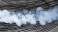 Black tire marks and white smoke on asphalt race track, Road dust cloud from driving car, Combustion fumes of car exhaust pipe, Royalty Free Stock Photo