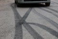 Black tire traces on asphalt.