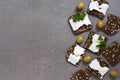 Black toasted bread with cheese and grains on a gray surface. View from above. Royalty Free Stock Photo