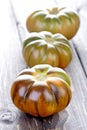 Black tomatoes on wooden table