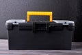 Black tool box with yellow handle. Royalty Free Stock Photo