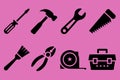 Black tools on pink background screwdriver hammer Royalty Free Stock Photo