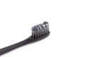 A Black Toothbrush with Black Activated Charcoal Toothpaste on a White Background Royalty Free Stock Photo