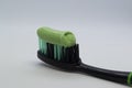 A black toothbrush with toothpaste. Royalty Free Stock Photo