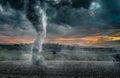 Black tornado funnel over field during thunderstorm