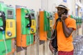 Black tourist man talking on payphone while thinking Royalty Free Stock Photo