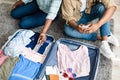 Black Tourists Couple Putting Sanitizer Packing Travel Suitcase At Home Royalty Free Stock Photo