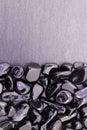 Black tourmaline jewel heap on black stone half background. Pile mineral pebbles texture.
