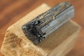 Black tourmaline stone on a background of natural wood American