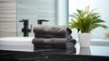 Black towels on marble desk in the foreground and blurred modern bathroom Royalty Free Stock Photo