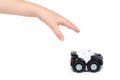 Black toy police car with kid hand, isolated on white background Royalty Free Stock Photo