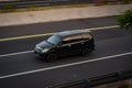 Black Toyota avanza driving fast on the trans jawa highway at afternoon blurry in motion