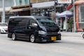 Black Toyota Commuter Hiace with big alloy wheels on the road in the city with traffic