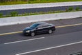 Black Toyota Corolla Altis driving fast on the trans jawa highway