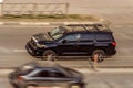 Black Toyota Seqouia SUV vehicle on the city road. Fast moving car on Moscow streets with blurred background. Accelerating with Royalty Free Stock Photo