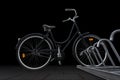 Black traditional parked bike on dark background