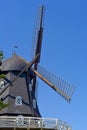 Black traditional swedish windmill with blue sky in summer Royalty Free Stock Photo