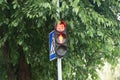 Black traffic light on a pole with red light