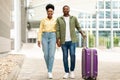 Black Travelers Couple Holding Hands Walking With Suitcase Outdoors Royalty Free Stock Photo