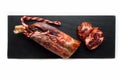 Black tray of delicious Iberian pork loin on white background Royalty Free Stock Photo