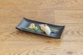 black tray with nigiri butterfish sushi with truffle on top on banana leaf ginseng Royalty Free Stock Photo