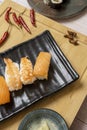 Black tray with Norwegian salmon nigiri sushi and spicy cooked prawns Royalty Free Stock Photo