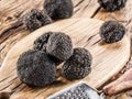 Black truffles on the old wooden table. Royalty Free Stock Photo