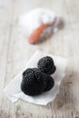 Black Truffles on Paper Napkin with Salt in Background