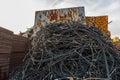 Black tube stack filled with wire rope in a junkyard