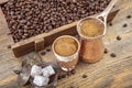 Black Turkish coffee in copper cup and roasted coffee beans scattered on wooden table. Traditional Turkish coffee in copper cup Royalty Free Stock Photo