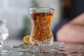 Tea in Azerbaijani traditional armudu pear-shaped glass . Azerbaijan black tea .white sugar cubes . Black turkish tea in pear Royalty Free Stock Photo