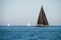 Black and two white sailing yachts on the sea Royalty Free Stock Photo