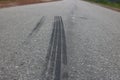 Black tyre marks of a vehicle on the street isolated creative stock photo