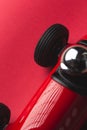 Black tyre wheel on a vintage red toy car