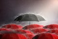 Black umbrella Among many red umbrellas against the storm,background sky and black cloud group, rainy and thunderstorm, with