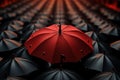 Black umbrellas blend, red stands alone - city background