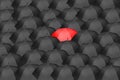 Black umbrellas with one red umbrella symbolizing innovation, bravery. Royalty Free Stock Photo