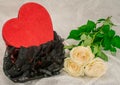 Black underwear knickers in gliter red box heart shaped white roses on white background Royalty Free Stock Photo